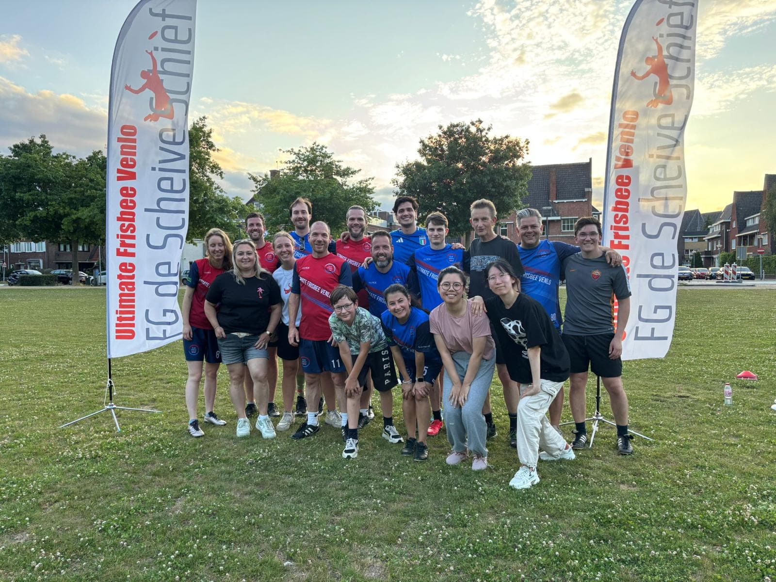 Group of participants between the club flags during Frisbee @ the Park